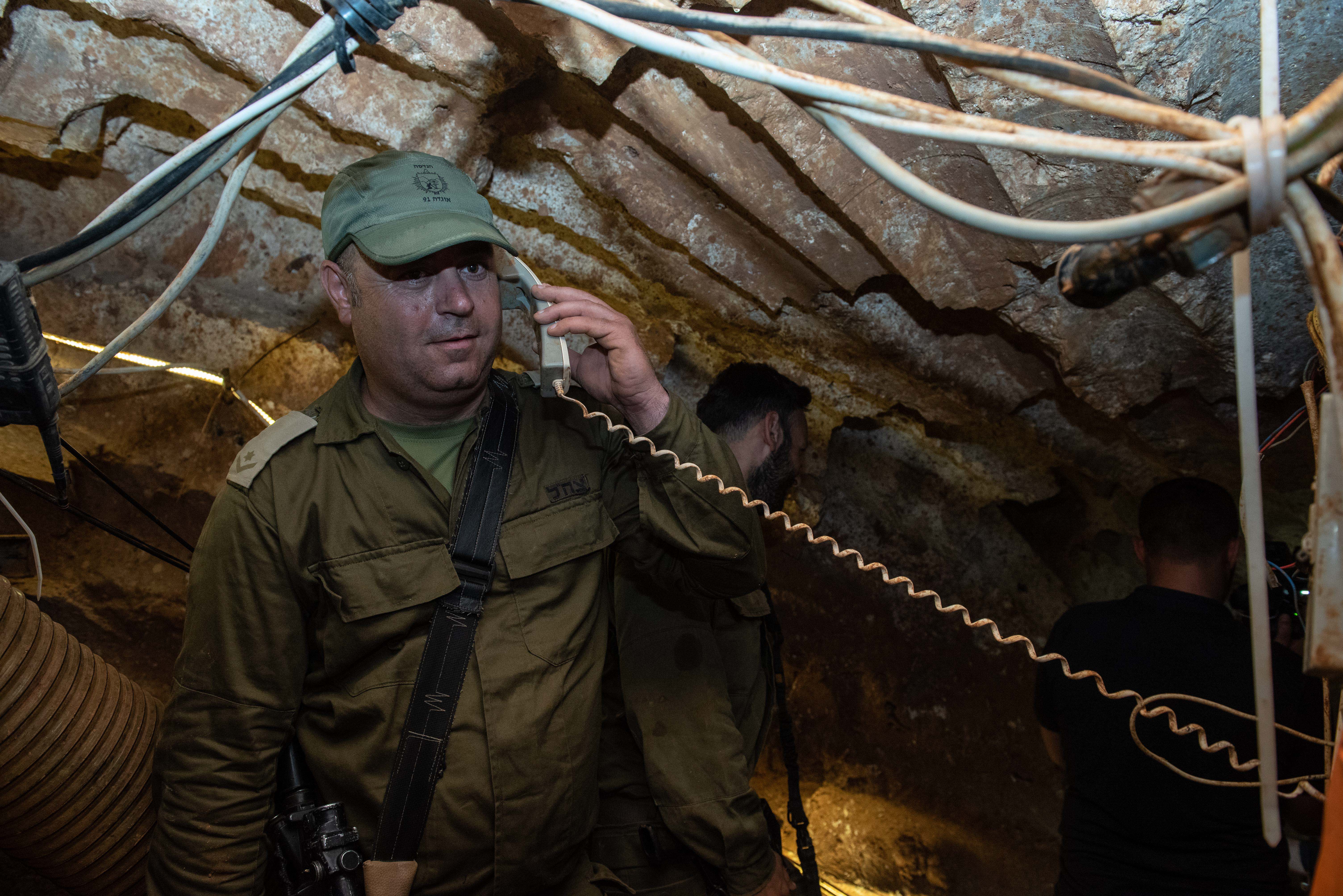 An Israeli soldier holding a telephone receiver that has been installed inside a Hezbollah tunnel that crosses from Lebanon to Israel, on the border between Israel and Lebanon in northern Israel, on May 29, 2019. Photo by: Ayal Margolin-JINIPIX