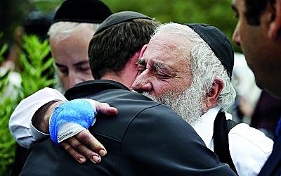 Rabbi Yisroel Goldstein hugs a member of the congregation of Chabad of Poway the day after a deadly shooting took place there, on Sunday, April 28, 2019 in Poway, Calif. (Credit Image: © TNS via ZUMA Wire)