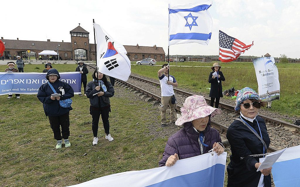 People from South Korea around the world walk with Israeli flags through the former Nazi German death camp of Auschwitz-Birkenau during the annual Holocaust remembrance event, the "March of the Living" in memory of the six million Holocaust victims in Oswiecim, Poland, Thursday, May 2, 2019. (AP Photo/Czarek Sokolowski)