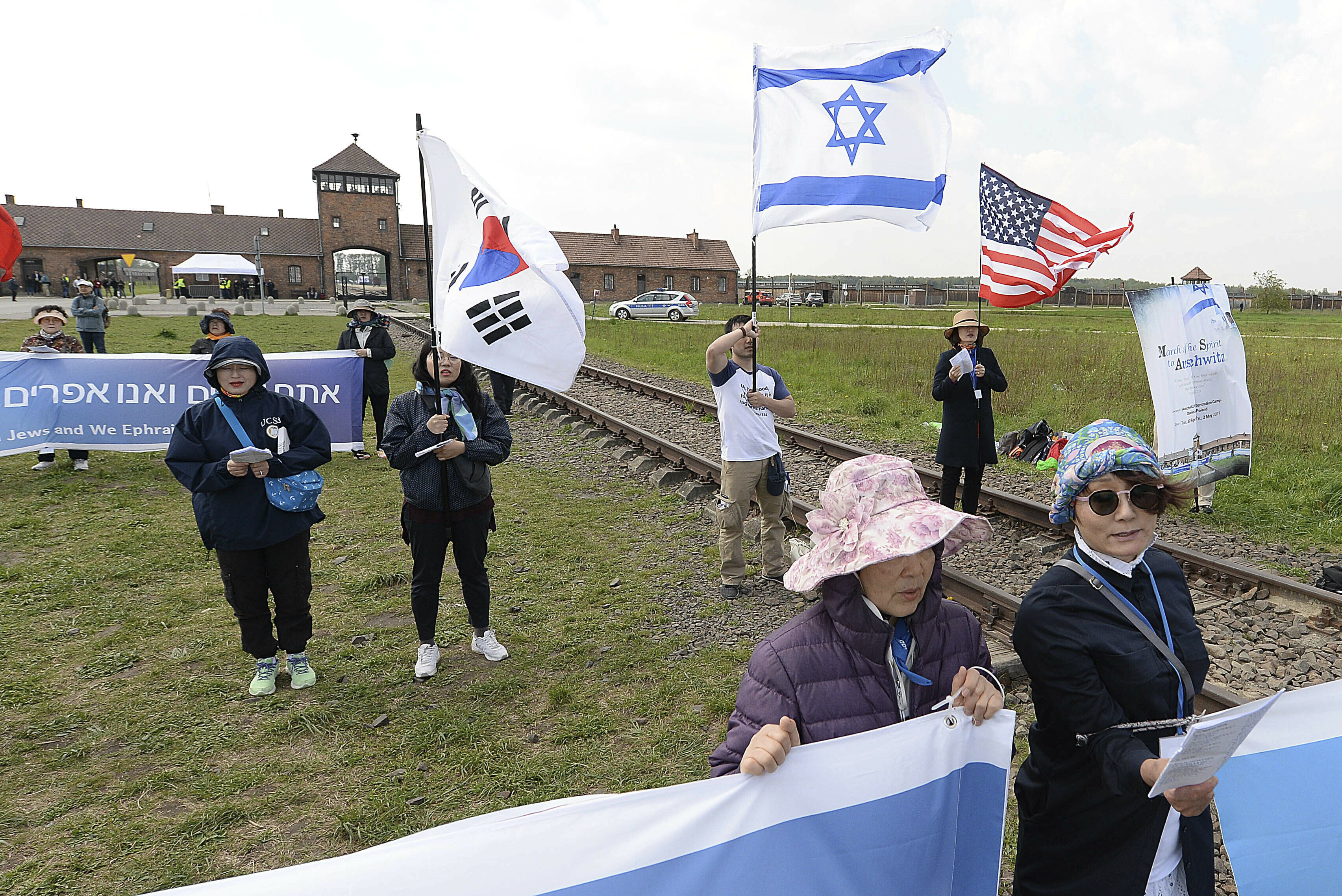 People from South Korea around the world walk with Israeli flags through the former Nazi German death camp of Auschwitz-Birkenau during the annual Holocaust remembrance event, the "March of the Living" in memory of the six million Holocaust victims in Oswiecim, Poland, Thursday, May 2, 2019. (AP Photo/Czarek Sokolowski)