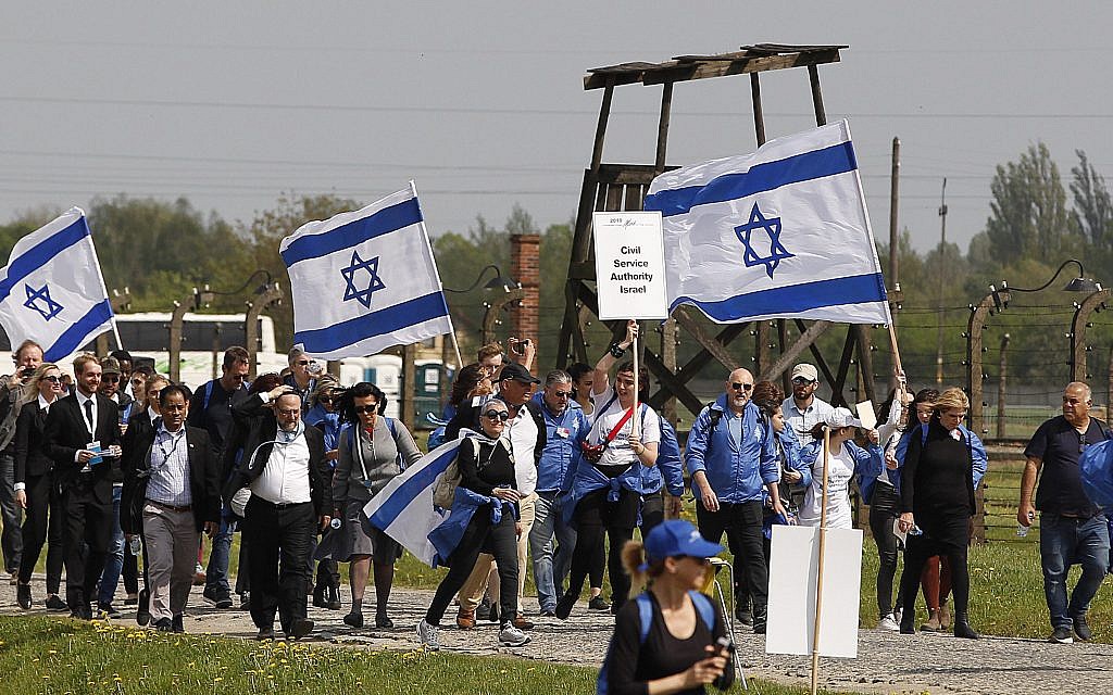 Young Jews from around the world walk with Israeli flags through the former Nazi German death camp of Auschwitz-Birkenau during the annual Holocaust remembrance event, the "March of the Living" in memory of the six million Holocaust victims in Oswiecim, Poland, Thursday, May 2, 2019.(AP Photo/Czarek Sokolowski)