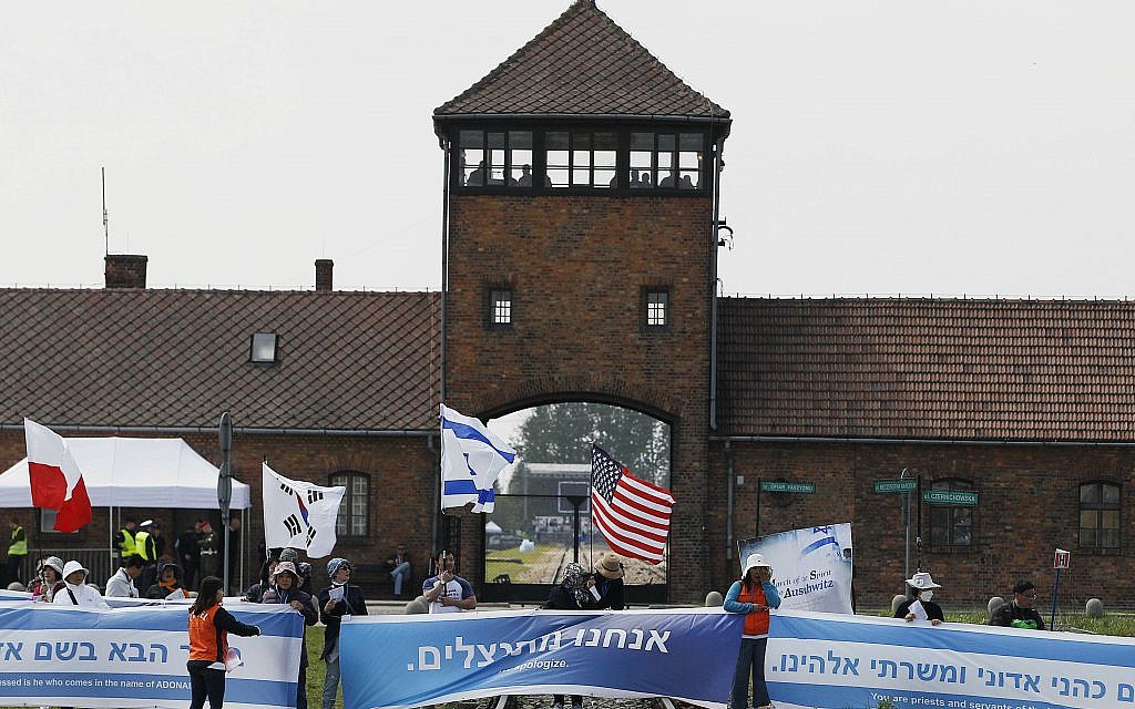 People from South Korea around the world walk with Israeli flags through the former Nazi German death camp of Auschwitz-Birkenau during the annual Holocaust remembrance event, the "March of the Living" in memory of the six million Holocaust victims in Oswiecim, Poland, Thursday, May 2, 2019. (AP Photo/Czarek Sokolowski)