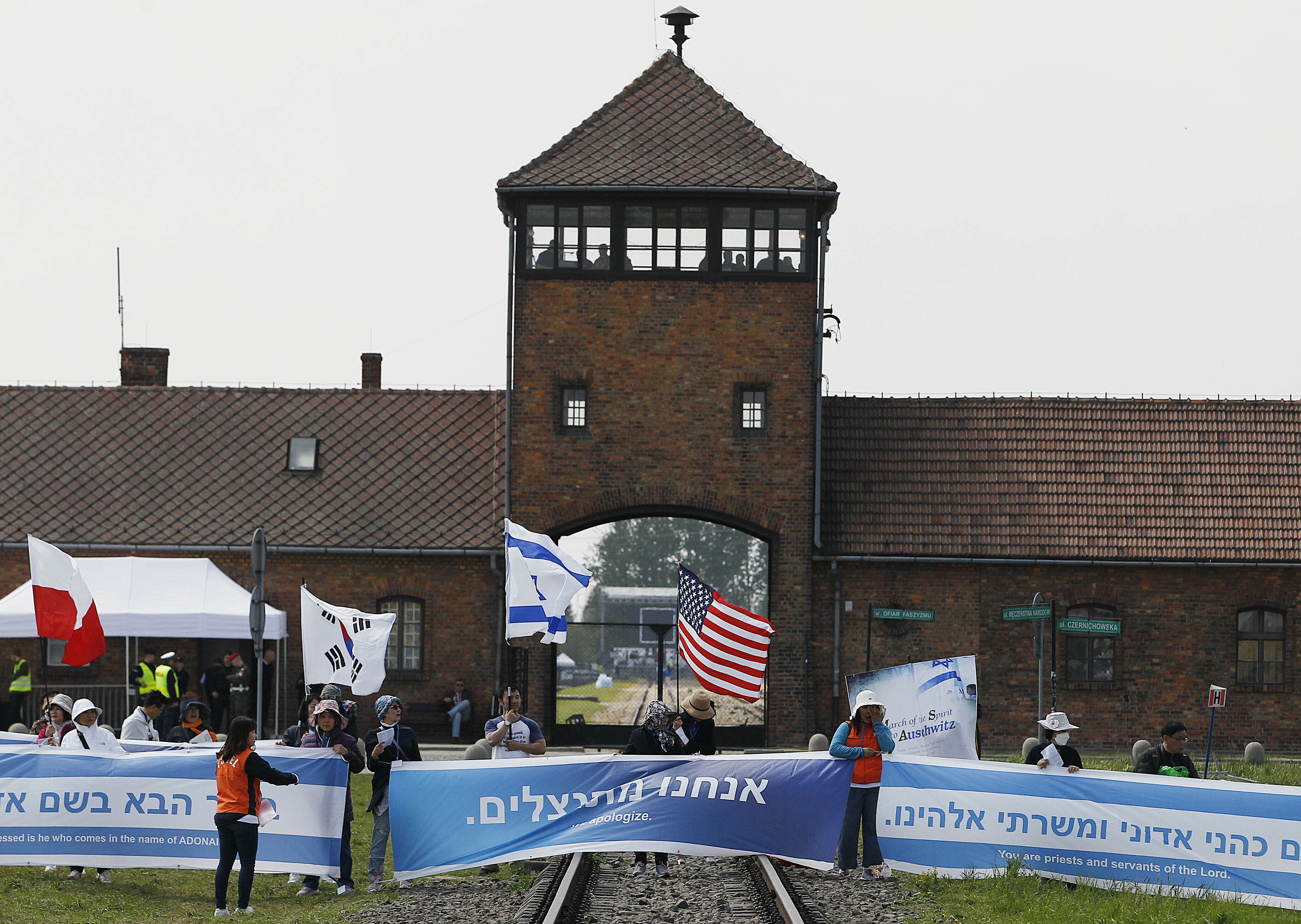 People from South Korea around the world walk with Israeli flags through the former Nazi German death camp of Auschwitz-Birkenau during the annual Holocaust remembrance event, the "March of the Living" in memory of the six million Holocaust victims in Oswiecim, Poland, Thursday, May 2, 2019. (AP Photo/Czarek Sokolowski)