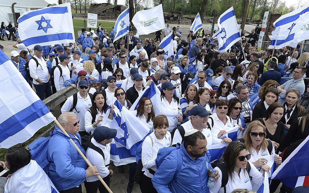Young Jews from around the world walk with Israeli flags through the former Nazi German death camp of Auschwitz-Birkenau during the annual Holocaust remembrance event, the "March of the Living" in memory of the six million Holocaust victims in Oswiecim, Poland, Thursday, May 2, 2019. (AP Photo/Czarek Sokolowski)