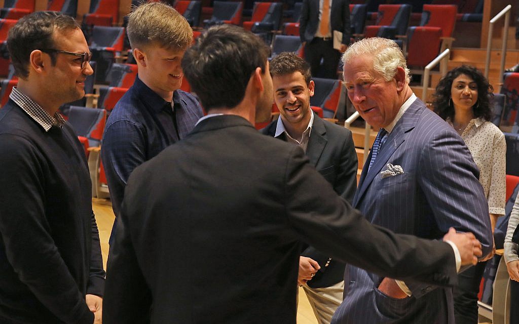 David Strongin (centre) put his hand on the The Prince of Wales's shoulder before congratulating him on "the English team's victory last night" during his visit to the Barenboim-Said Akademie, an academy located in Berlin, Germany, that offers bachelors degrees in music for talented young persons, most of them from the Middle East and North Africa. (Photo credit: Steve Parsons/PA Wire)