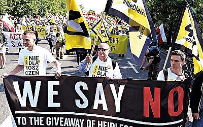 Thousands of Polish nationalists marched to the U.S. Embassy in Warsaw in May 2019, protesting that the U.S. is putting pressure on Poland to compensate Jews whose families lost property during the Holocaust.
 (AP Photo/Czarek Sokolowski)