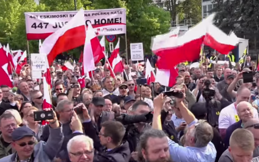 Screenshot from video by NPTV shows anti-restitution protesters, demonstrating against the US law 447