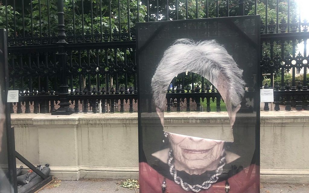 Holocaust survivor portraits have holes cut into them. Credit:  Luigi Toscano on Facebook