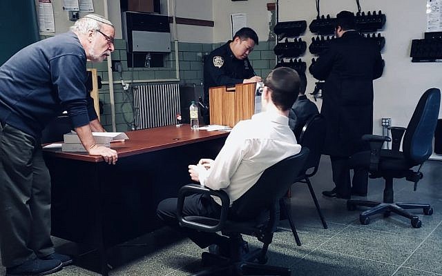 Chasidic teens in a police office being interviewed after reporting antisemitic abuse. 
Credit: Dov Hikind on Twitter