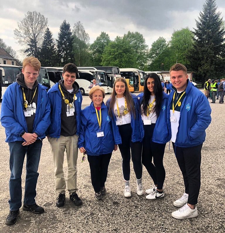Holocaust Educational Trust Ambassadors from the UK with Shoah survivor, Mala Tribich. The HET ambassadors are Georgia (George) Adkins, Jaya Pathak, Jamie Dickinson, James Milton and Jack Nicholls.