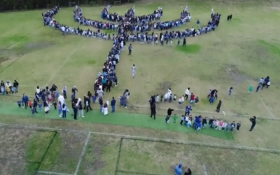 Screenshot from the school's video, showing them creating the world's largest menorah!