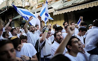 Israelis wave national flags in Jerusalem's Old City Sunday, June 2, 2019, during "Jerusalem Day, an Israeli holiday celebrating the capture of the Old City during the 1967 Mideast war. Photo by: JINIPIX