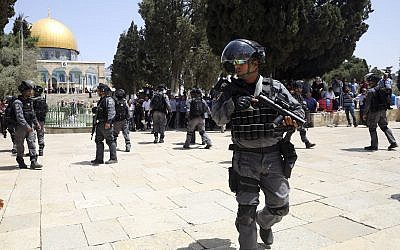 Israeli police officers take positions during clashes with Palestinians by the Dome of the Rock Mosque in the Al Aqsa Mosque compound in Jerusalem's old city, Sunday, June 2, 2019. (AP Photo/Mahmoud Illean)