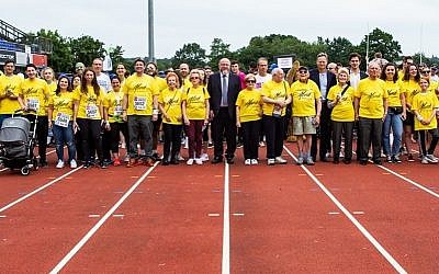 Survivors, surrounded by friends and family, and Chief Rabbi Ephraim Mirvis at last year's Maccabi GB Community Fun Run
 
(Credit: Blake Ezra Photography)