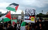 Protesters wave Palestinian flags and hold placards during a pro-Palestinian demonstration