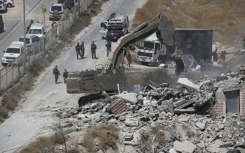 Israeli forces destroy a building in a Palestinian village of Sur Baher, east Jerusalem,, July 22, 2019. . (AP Photo/Mahmoud Illean)