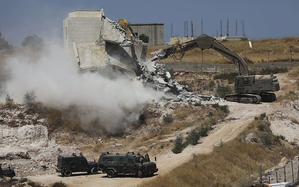 Israeli forces destroy a building in a Palestinian village of Sur Baher, east Jerusalem, Monday, July 22, 2019. . (AP Photo/Mahmoud Illean)