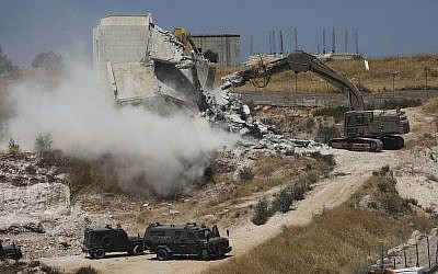 Israeli forces destroy a building in a Palestinian village of Sur Baher, east Jerusalem, Monday, July 22, 2019. . (AP Photo/Mahmoud Illean)