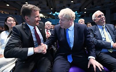 Jeremy Hunt (second left) congratulates Boris Johnson (second right) after he is announced as the new Conservative party leader. Photo credit: Stefan Rousseau/P/A Wire