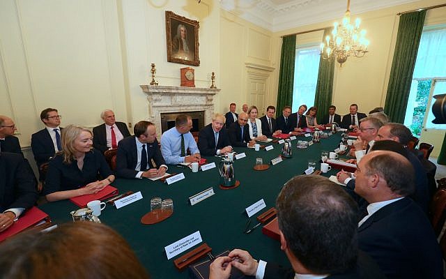 (from left, seated at table) International Trade Secretary Liz Truss, Health and Social Care Secretary Matt Hancock, Cabinet Secretary Sir Mark Sedwill, Prime Minister Boris Johnson, Chancellor of the Exchequer Sajid Javid, Works and Pensions Secretary and Minister for Women Amber Rudd,  Housing, Communities and Local Government Secretary Robert Jenrick, Transport Secretary Grant Shapps, Scottish Secretary Alister Jack, Culture Scretary Nicky Morgan, Chief Secretary to the Treasury Rishi Sunak, and Chief Whip Mark Spencer, as Prime Minister Boris Johnson holds his first Cabinet meeting at Downing Street in London. (Photo credit: Aaron Chown/PA Wire)