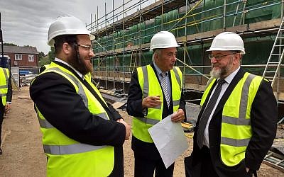 Benjamin Perl (centre) and the Chief Rabbi with Rabbi Tuvia Freund from Israel at the site of the new school building.
