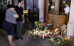 Mourners visit a makeshift memorial outside Ned Peppers bar following a vigil at the scene of a mass shooting, Sunday, Aug. 4, 2019, in Dayton, Ohio. A masked gunman in body armor opened fire early Sunday in the popular entertainment district in Dayton, killing several people, including his sister, and wounding dozens before he was quickly slain by police, officials said. (AP Photo/John Minchillo) Mourners visit a makeshift memorial outside Ned Peppers bar following a vigil at the scene of a mass shooting, Sunday, Aug. 4, 2019, in Dayton, Ohio. A masked gunman in body armor opened fire early Sunday in the popular entertainment district in Dayton, killing several people, including his sister, and wounding dozens before he was quickly slain by police, officials said. (AP Photo/John Minchillo)