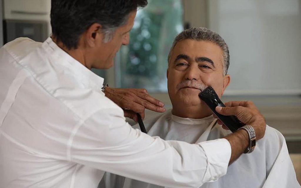 Amir Peretz having his moustache shaved off (Source: https://www.facebook.com/Peretz.Amir/)