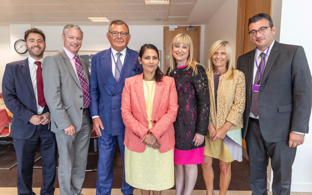 From left:  Phil Rosenberg, Director of Public Affairs, Board of Deputies of British Jews, Simon Johnson,  Chief Executive, Jewish Leadership Council, Gerald Ronson CBE, Chair, Community Security Trust, Rt Hon Priti Patel MP, Home Secretary, Marie van der Zyl, President, Board of Deputies of British Jews, Debra Fox, Vice-Chair, Jewish Leadership Council, Mark Gardner, Director of Communications, Community Security Trust