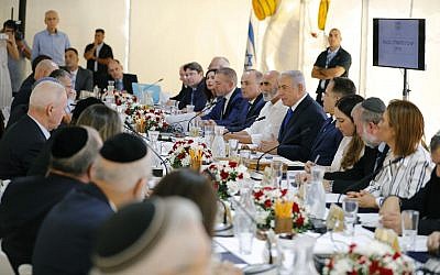 Israeli Prime Minister Benjamin Netanyahu chairs the weekly cabinet meeting being held in a makeshift tent in the Jordan Valley, in the West Bank. (Amir Cohen/Pool via AP)
