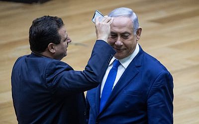 Joint List party leader Ayman Odeh filming Israeli Prime Minister Benjamin Netanyahu during a discussion on the Security Cameras Law, at the Knesset, in Jerusalem on September 11, 2019. Photo by Yonatan Sindel/Flash90 *** Local Caption *** איימן עודה
תאריך
כנסת
מליאה
הצבעה
חוק המצלמות
ביבי 
בנימין נתניהו