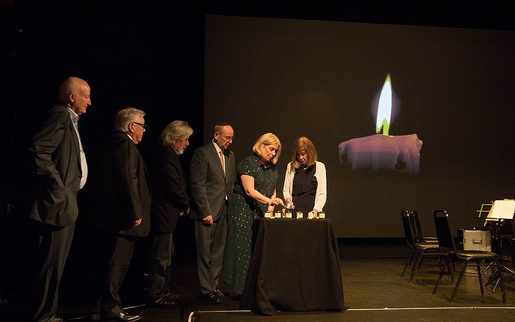Gena Turgel's family lighting six candles to remember those who perished in the Shoah (Credit: Daniel Morris)