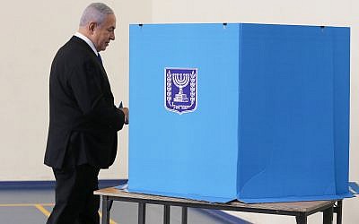 Israeli Prime Minister Benjamin Netanyahu prepares to cast his ballot during the Israeli elections, at a polling station in Jerusalem. (Photo by: Alex kolomoisky-JINIPIX)