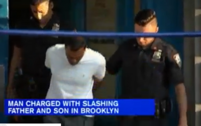 Screenshot from WABC-TV video shows a suspect being led away by police in handcuffs