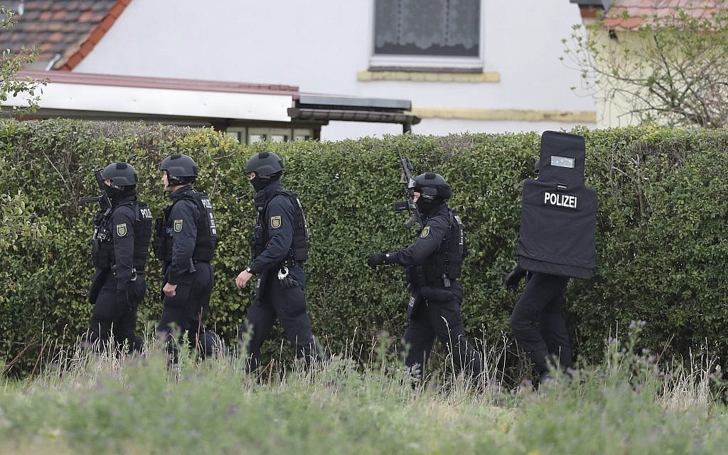 Police officers secure the surrounding of Landsberg, Germany, Wednesday, Oct. 9, 2019. One or more gunmen fired several shots on Wednesday in the German city of Halle. Police say a person has been arrested after a shooting that left two people dead. (Jan Woitas/dpa via AP) Police officers secure the surrounding of Landsberg, Germany, Wednesday, Oct. 9, 2019. One or more gunmen fired several shots on Wednesday in the German city of Halle. Police say a person has been arrested after a shooting that left two people dead. (Jan Woitas/dpa via AP)