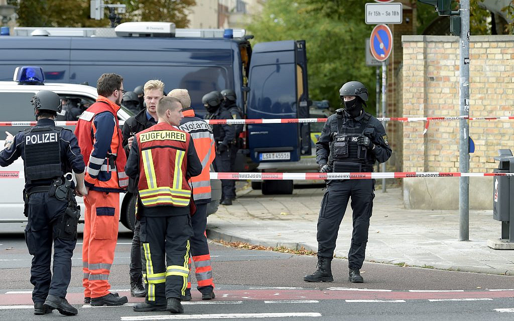 Police officers and paramedics stay in front of a Jewish cemetery in Halle, Germany, Wednesday, Oct. 9, 2019 after the Halle attack (AP Photo Jens Meyer) Police officers and paramedics stay in front of a Jewish cemetery in Halle, Germany, Wednesday, Oct. 9, 2019 after the Halle attack (AP Photo Jens Meyer)