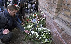 People place down flowers in front of a synagogue in Halle, Germany, Thursday, Oct. 10, 2019 (AP Photo/Jens Meyer) People place down flowers in front of a synagogue in Halle, Germany, Thursday, Oct. 10, 2019 (AP Photo/Jens Meyer)