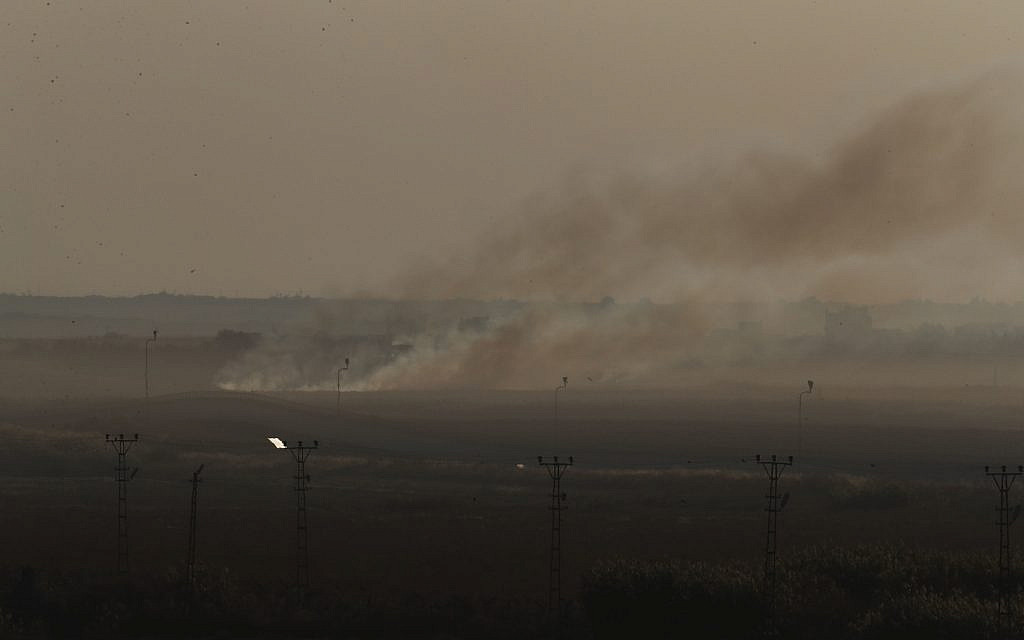 In this photo taken from the Turkish side of the border between Turkey and Syria, in Akcakale, Sanliurfa province, southeastern Turkey, smoke billows from target in Tel Abyad, Syria, during bombardment by Turkish forces, Saturday, Oct. 12, 2019. (AP Photo/Lefteris Pitarakis)