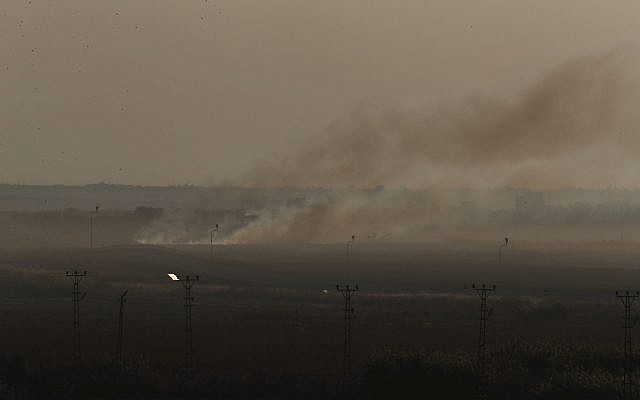 In this photo taken from the Turkish side of the border between Turkey and Syria, in Akcakale, Sanliurfa province, southeastern Turkey, smoke billows from target in Tel Abyad, Syria, during bombardment by Turkish forces, Saturday, Oct. 12, 2019. (AP Photo/Lefteris Pitarakis)