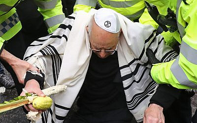 Rabbi Jeffrey Newman is arrested as protesters continue to block the road outside Mansion House in the City of London, during an XR climate change protest. Rabbi. Photo credit: Gareth Fuller/PA Wire