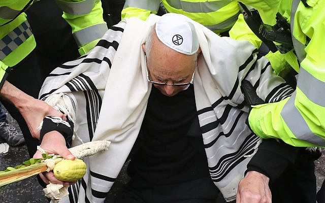Rabbi Jeffrey Newman is arrested as protesters continue to block the road outside Mansion House in the City of London, during an XR climate change protest. Rabbi. Photo credit: Gareth Fuller/PA Wire