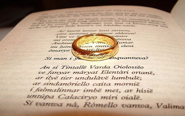 A page of the book The Lord of the Rings, along with a replica of the Unique Ring in the middle. (Wikipedia/ Zanastardust https://www.flickr.com/photos/zanastardust/146652127/)