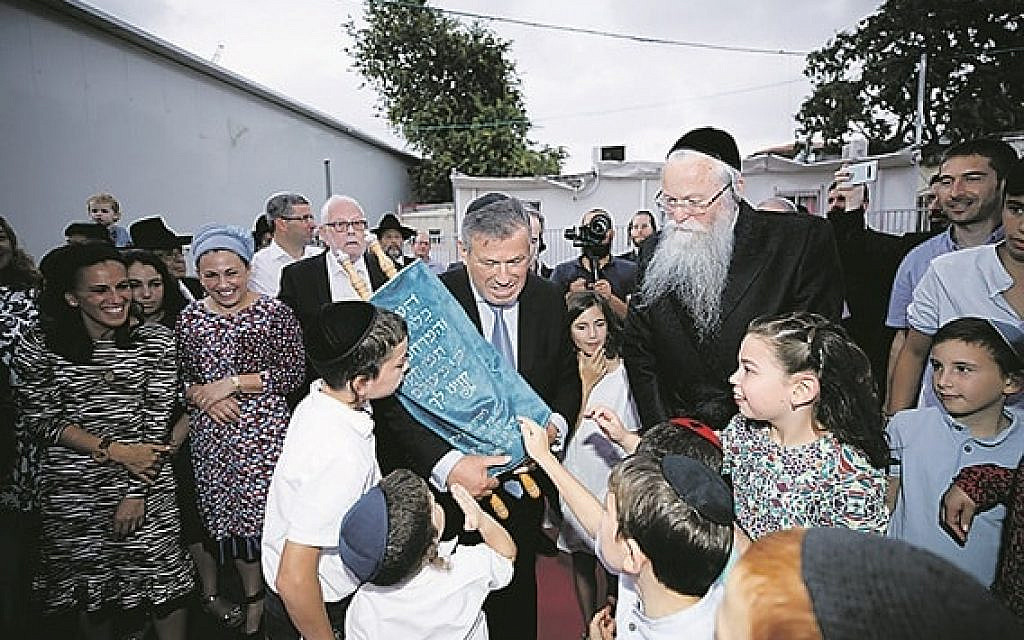 Leo with the Sefer Torah marking the opening of the new centre