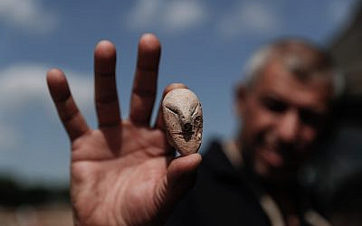 A picture taken on October 06, 2019 shows a figurine of a human face unearthed at the archaeological site of En Esur (Ein Asawir) where a 5000-year-old city was uncovered, near the Israeli town of Harish on October 06, 2019. Photo by: JINIPIX