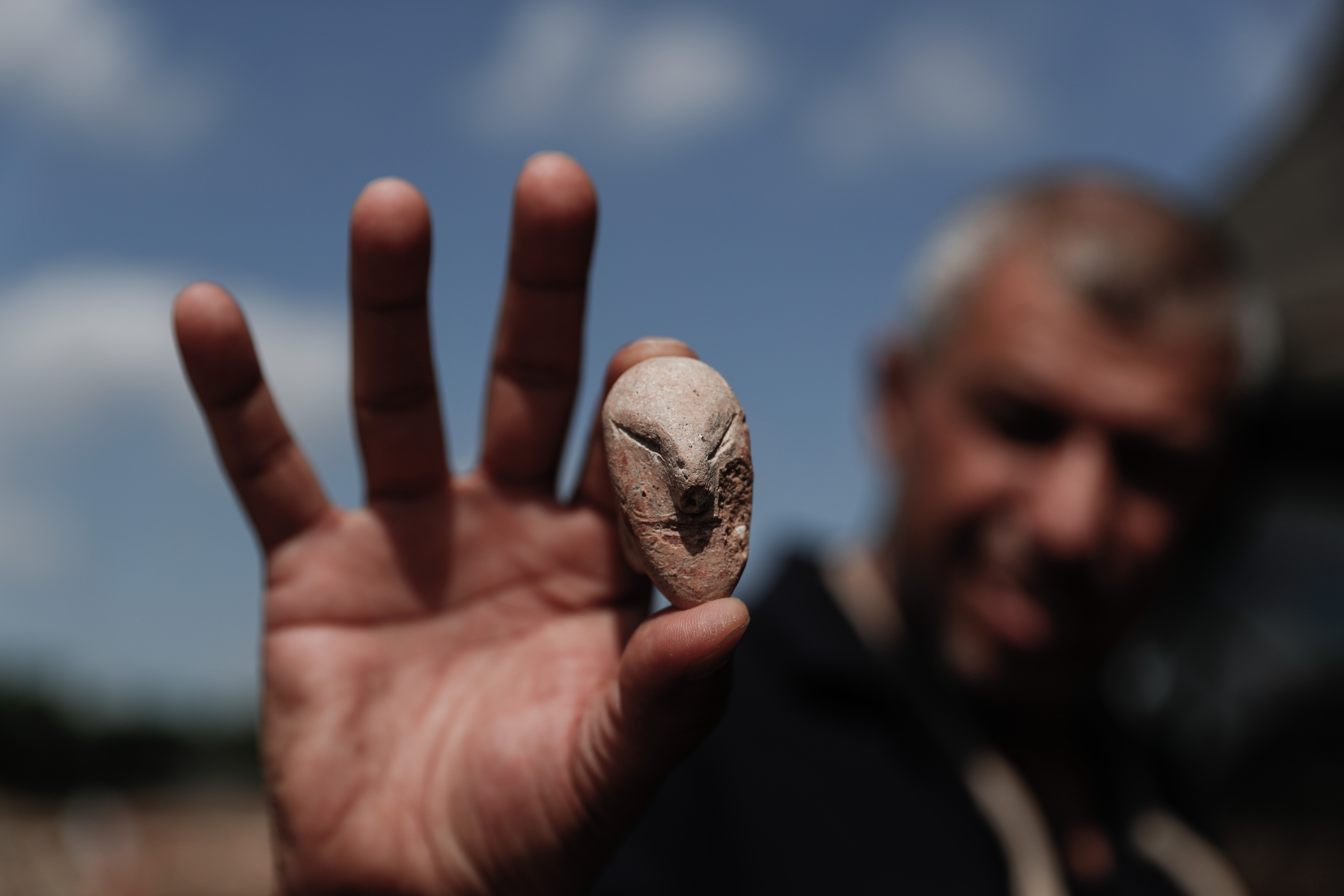A picture taken on October 06, 2019 shows a figurine of a human face unearthed at the archaeological site of En Esur (Ein Asawir) where a 5000-year-old city was uncovered, near the Israeli town of Harish on October 06, 2019. Photo by: JINIPIX