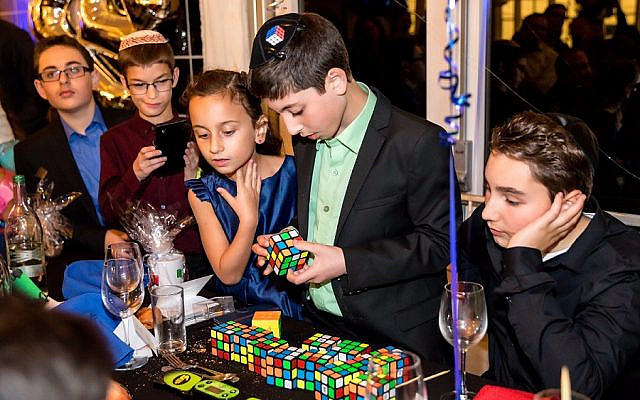 Pictured 13 year-old Rafi Niman, from Borehamwood, solved 13 Rubik's cube in under four minutes at his bar mitzvah