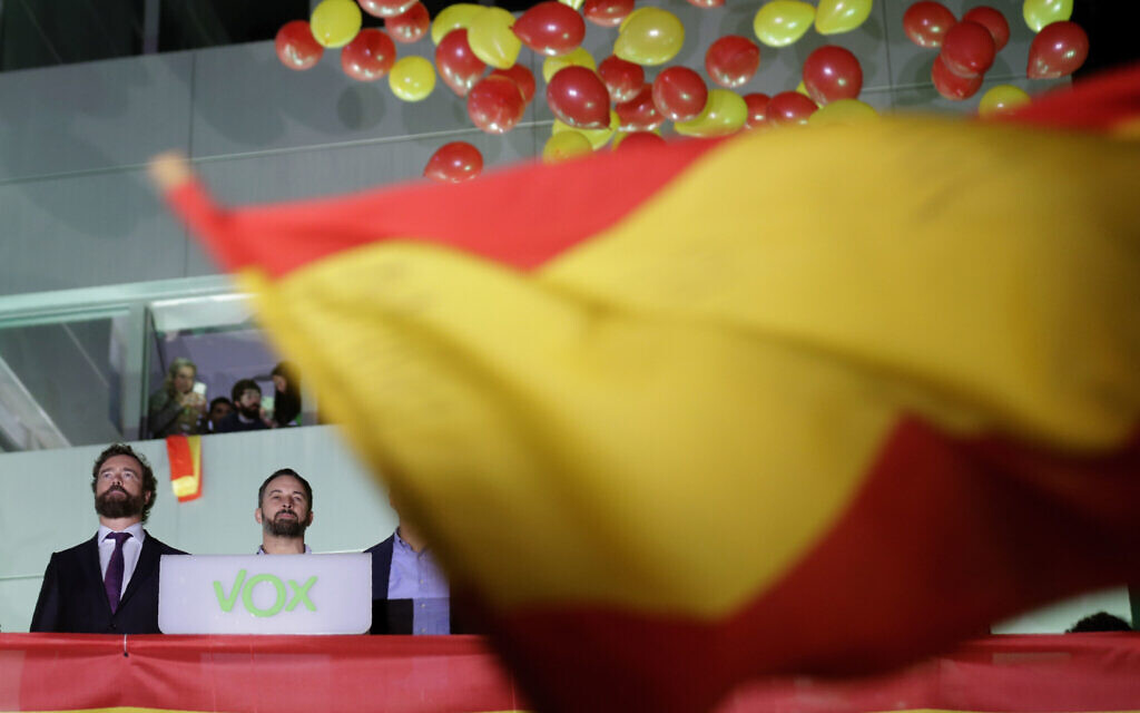 Santiago Abascal, leader of far-right Vox Party, 2nd left, looks at supporters outside the party headquarters after the announcement of the general election first results, in Madrid, Spain, Sunday, Nov. 10, 2019.   (AP Photo/Andrea Comas)