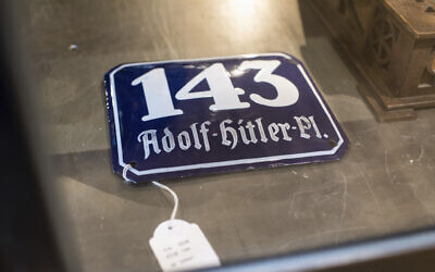 A street sign for '143 Adolf Hitler Place' is displayed for an auction at the 'Hermann Historica' auction house in Grasbrunn near Munich, Germany. A Geneva businessman says he has purchased Adolf Hitler's top hat and other Nazi memorabilia to keep them out of the hands of neo-Nazis and will donate them to a Jewish group. (Matthias Balk/dpa via AP)