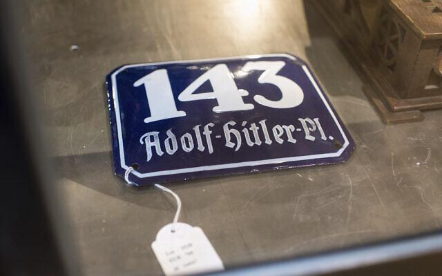 A street sign for '143 Adolf Hitler Place' is displayed for an auction at the 'Hermann Historica' auction house in Grasbrunn near Munich, Germany. A Geneva businessman says he has purchased Adolf Hitler's top hat and other Nazi memorabilia to keep them out of the hands of neo-Nazis and will donate them to a Jewish group. (Matthias Balk/dpa via AP)