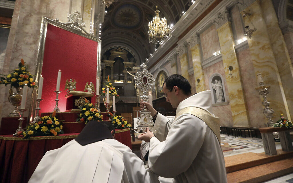 Christian clergymen carry a wooden relic believed to be from Jesus' manger at the Church of Saint Saviour in Jerusalem's old city, Friday, Nov. 29, 2019.   (AP Photo/Mahmoud Illean)