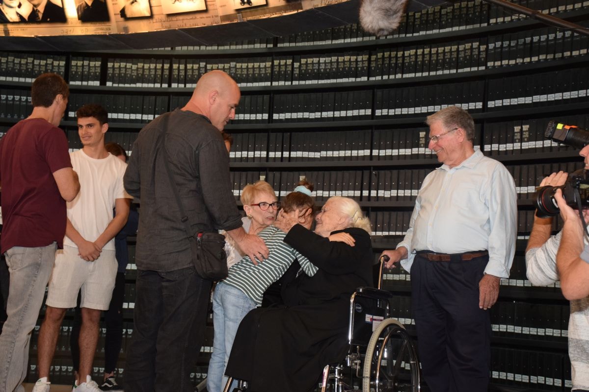 Holocaust survivors and their family meet Righteous Among the Nations Melpomeni Dina at Yad Vashem's Hall of Names
 (Credit: Yad Vashem)